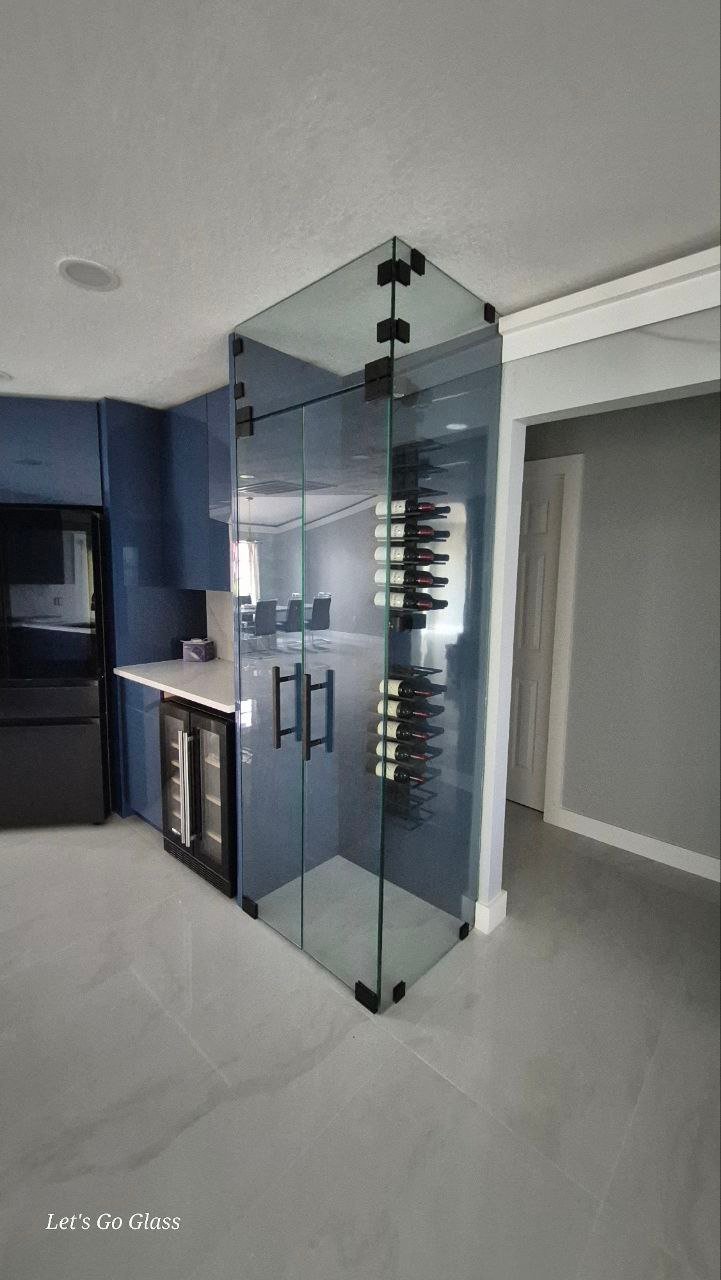 Custom glass wine cellar enclosure in modern kitchen
